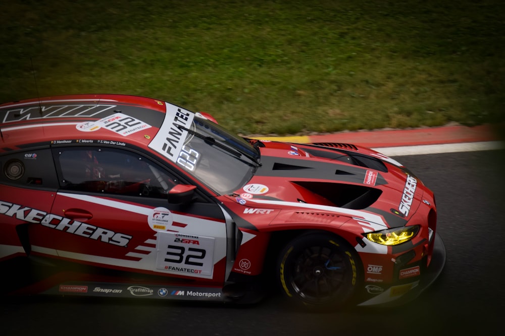 a red sports car driving down a race track