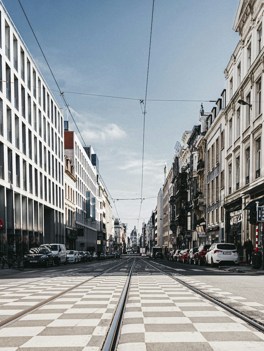 a city street with a train track running through it