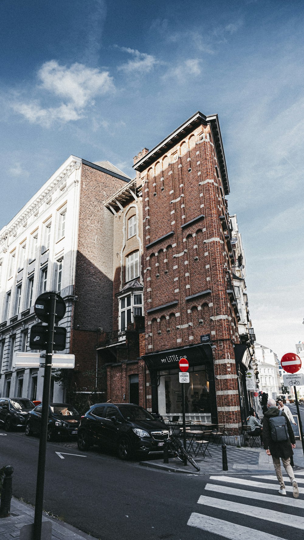 a tall brick building sitting on the side of a road