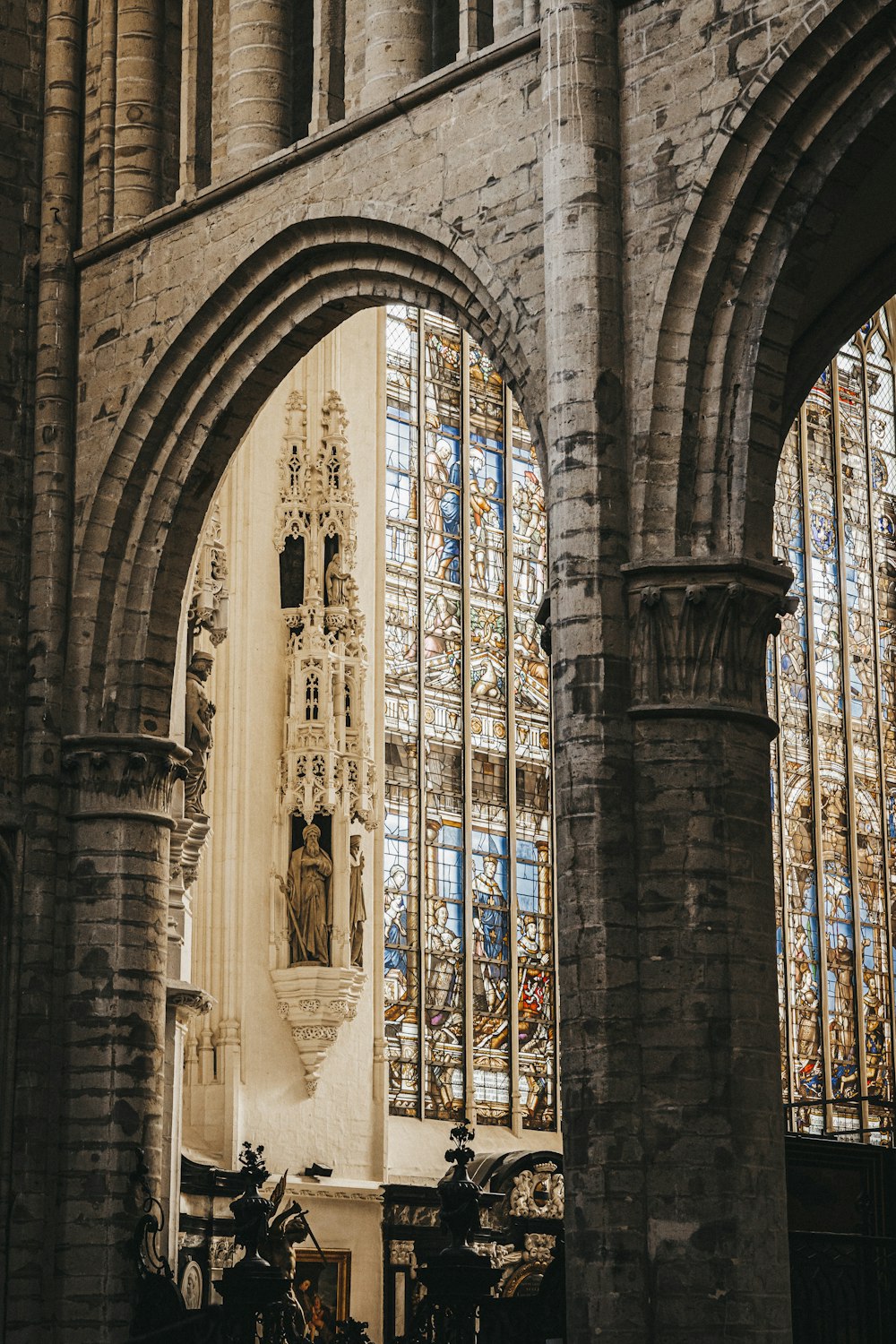 a cathedral with stained glass windows and a statue