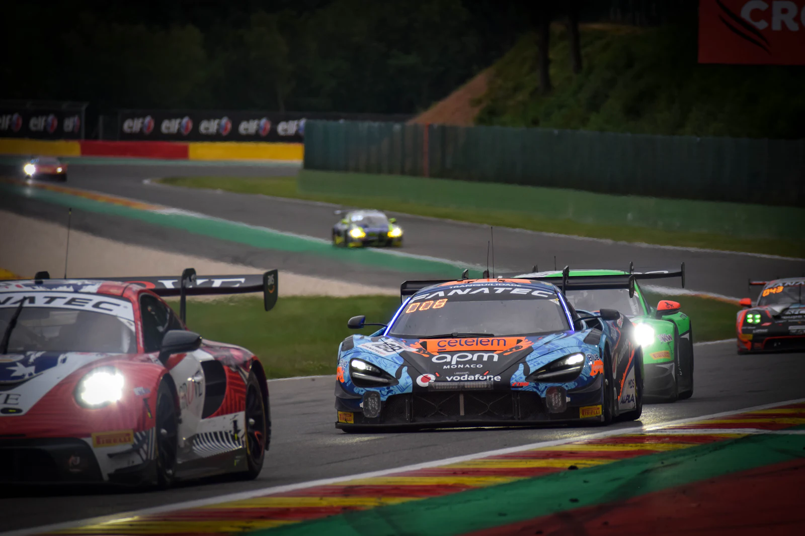 Racing cars mid-race on a circuit