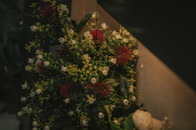 Elegant arrangement of fresh red and green flowers with warm lighting