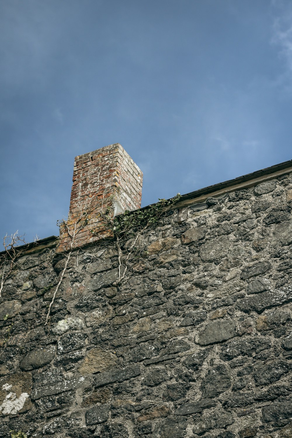 a stone wall with a brick tower on top