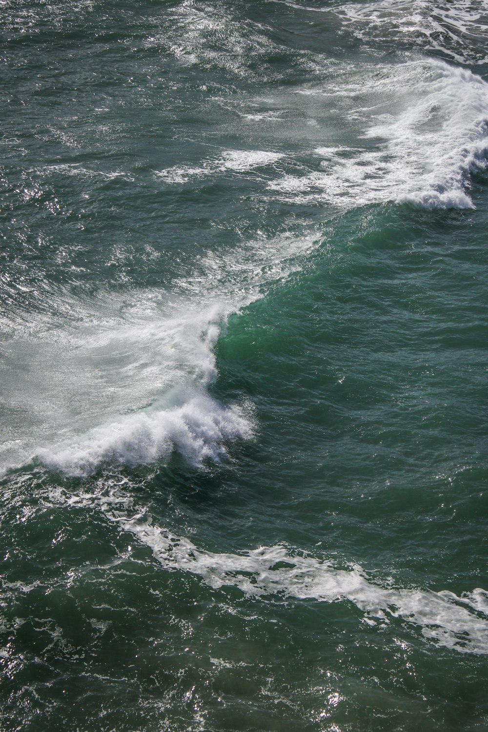 a person riding a surfboard on a wave in the ocean