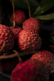a pile of red fruit sitting on top of a table