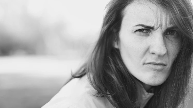 a black and white photo of a woman with long hair