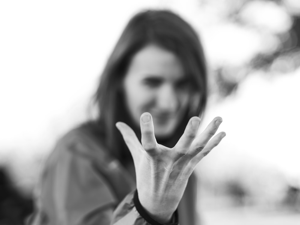 a woman making the vulcan sign with her hand