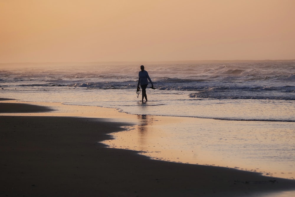 a person riding a surf board on a beach