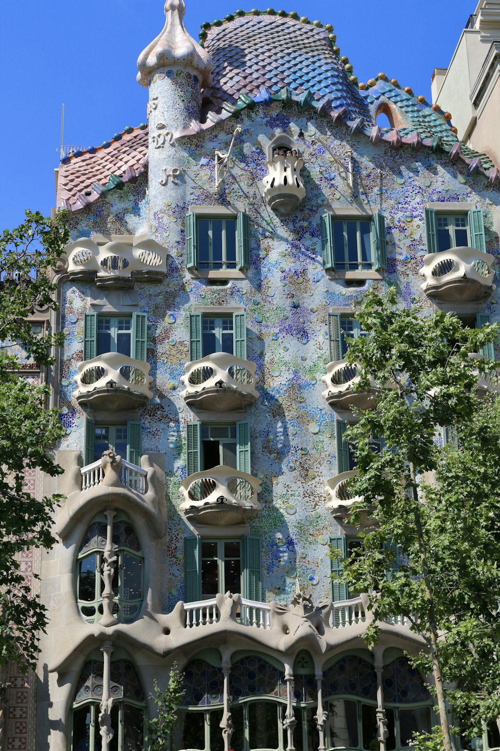 a tall building with many windows and balconies