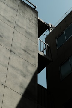 Before and after images of concrete repair on a building corner.