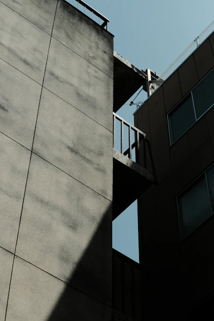 Before and after shots of a building facade showing waterproofing treatment effects