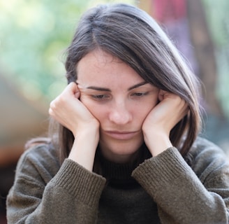 a woman holding her head in her hands