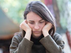 a woman holding her head in her hands