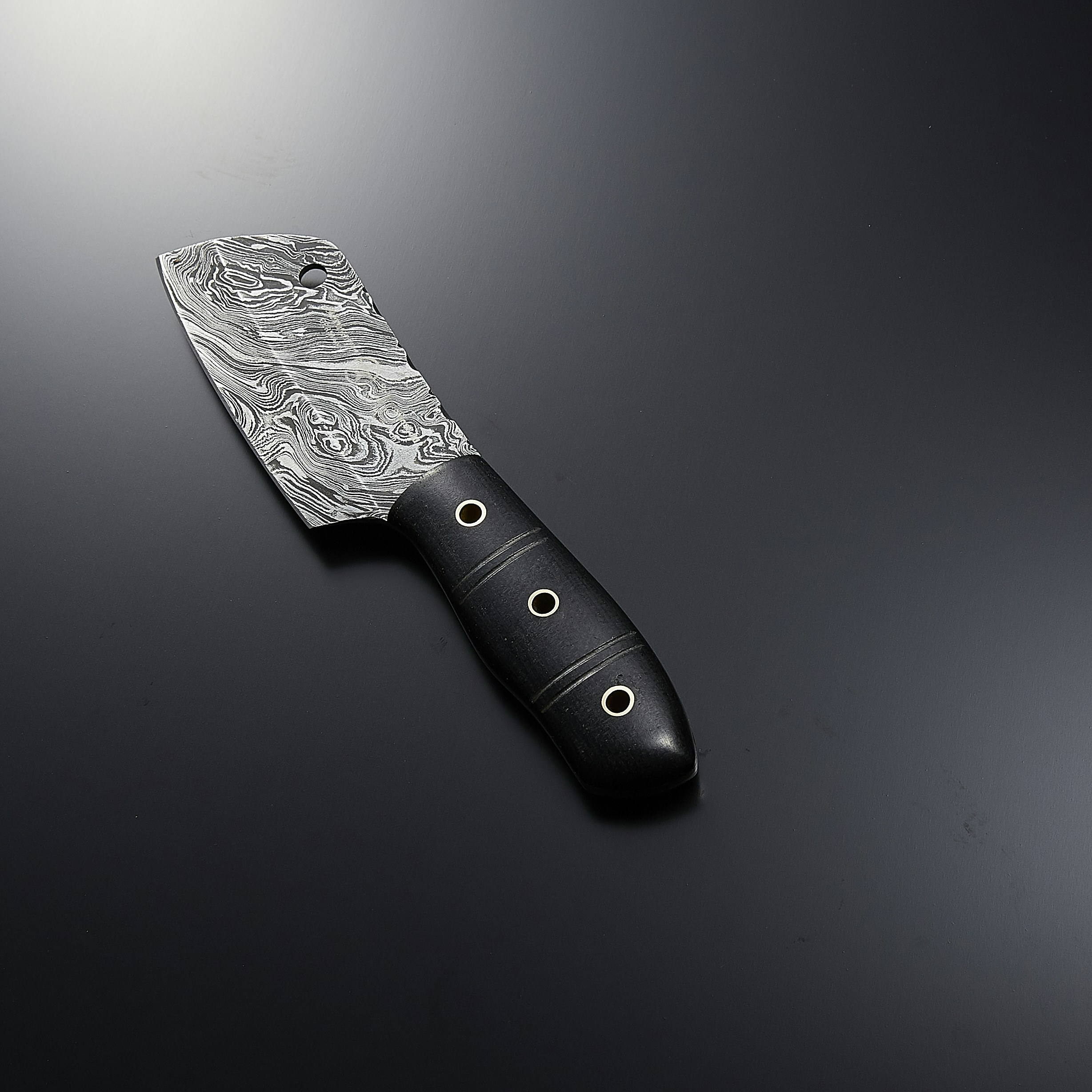a knife with a black handle sitting on a table
