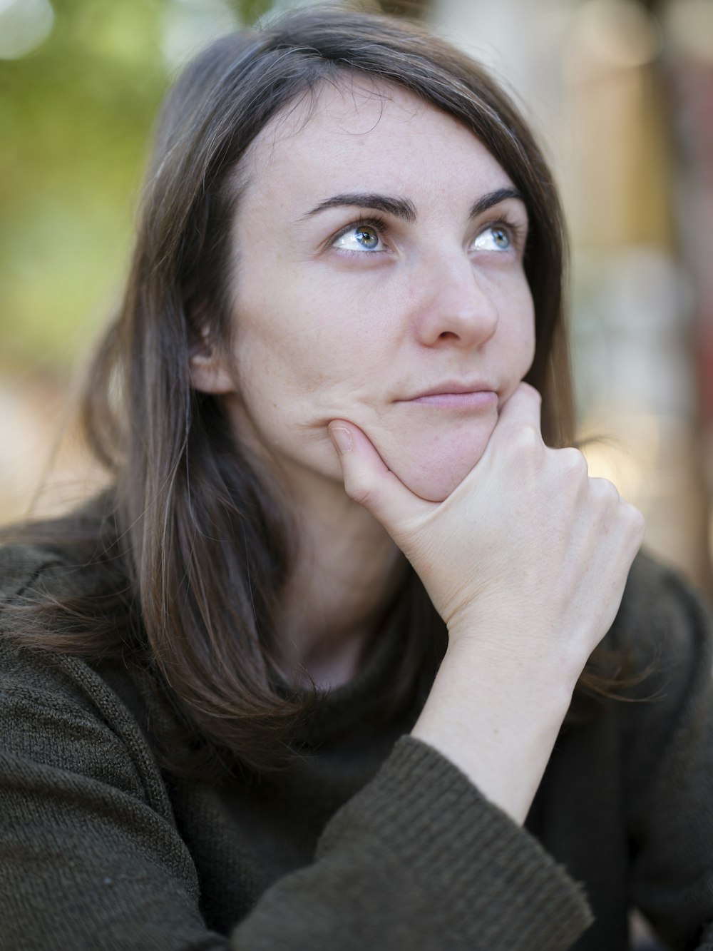 a woman with her chin resting on her hand