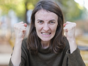 a woman holding her fists up in the air