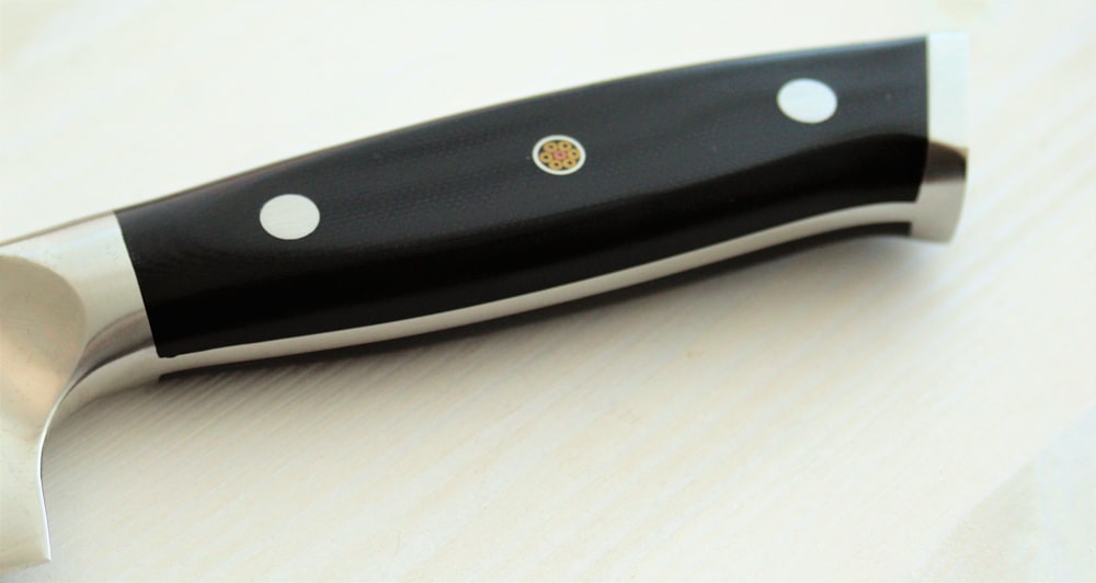 a knife with a black handle on a table