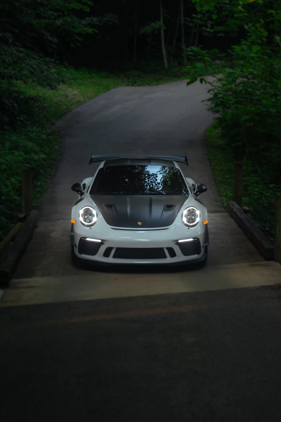 Silver Porsche 911 GT3 RS front view on a forest road