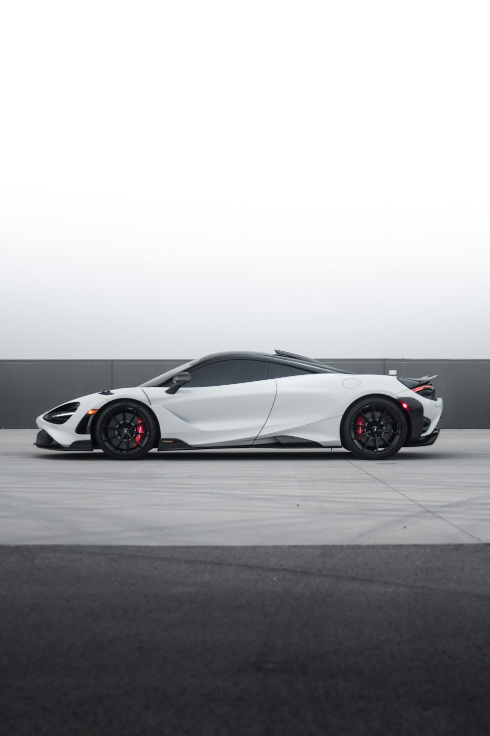 a white sports car parked in a parking lot