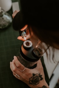 a woman with a tattoo on her arm taking a picture with a camera