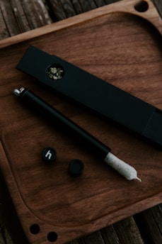 White powder neatly arranged with a small rolling paper and grinder nearby