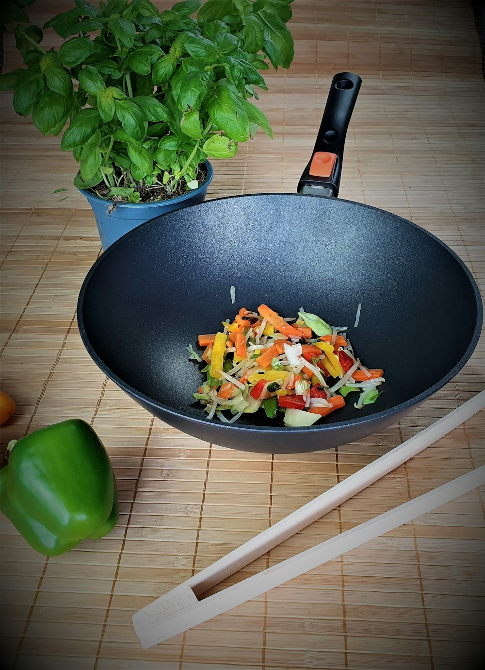 a salad in a bowl with chopsticks next to it