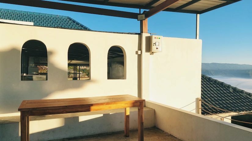 A sunlit terrace at Torre Palazzone overlooking rolling Tuscan hills at golden hour.