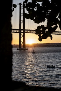 a boat is in the water near a bridge