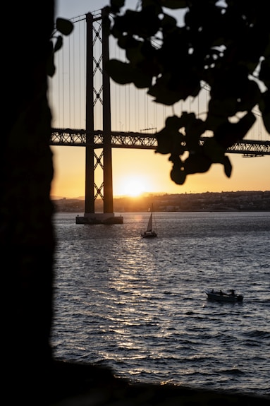 a boat is in the water near a bridge