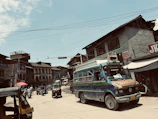 A vibrant street scene in Kathmandu with colorful vehicles and bustling activity.