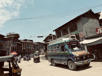A Ruhaan taxi cruising past colorful streets of Panjim under a clear blue sky.