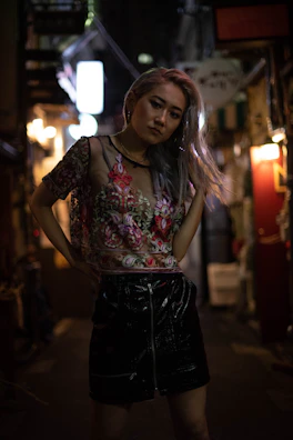 Model walking confidently down a neon-lit alley wearing bold streetwear with glowing accents.