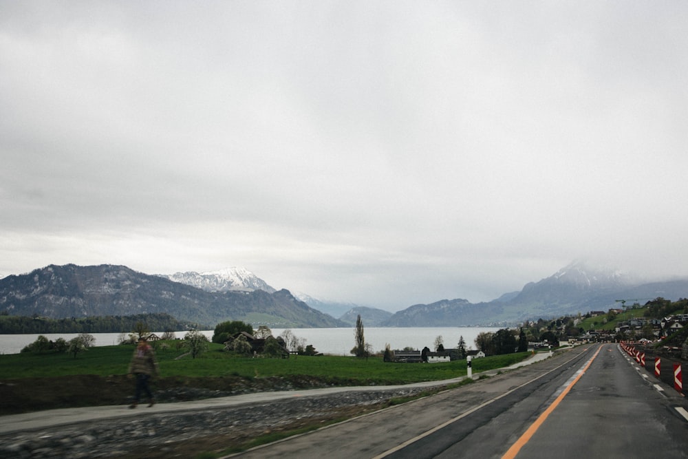 a group of people standing on the side of a road