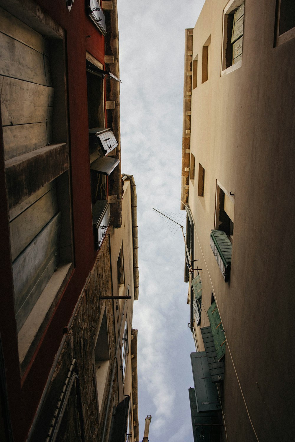 looking up at a narrow alleyway in a city