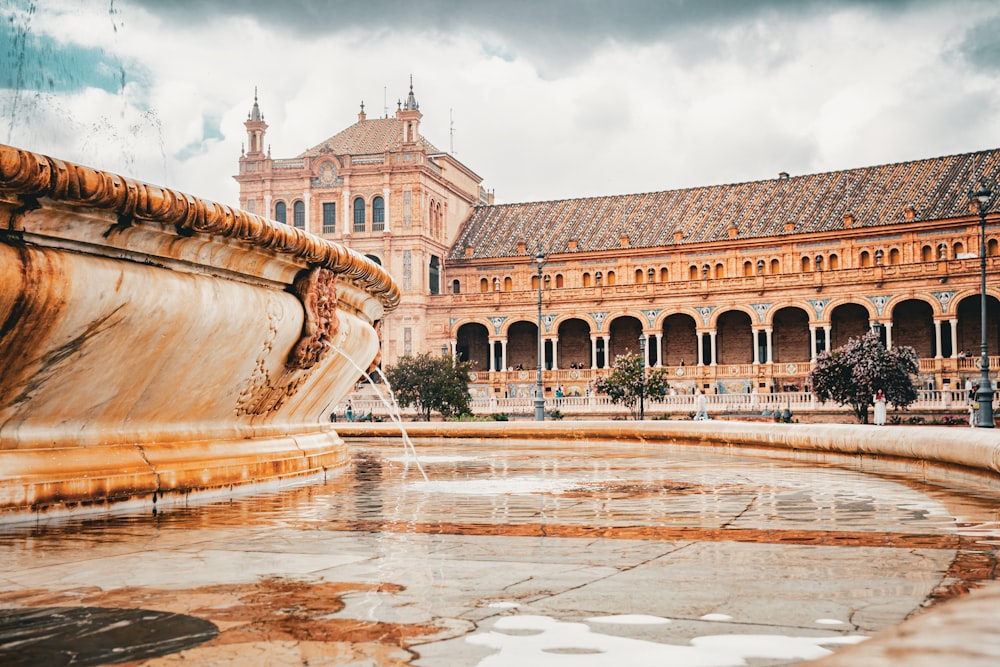 a large building with a fountain in front of it