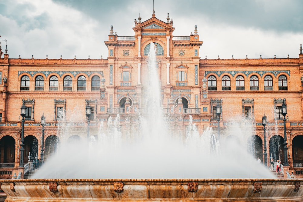 a large building with a fountain in front of it