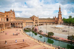 a large building with a fountain in front of it