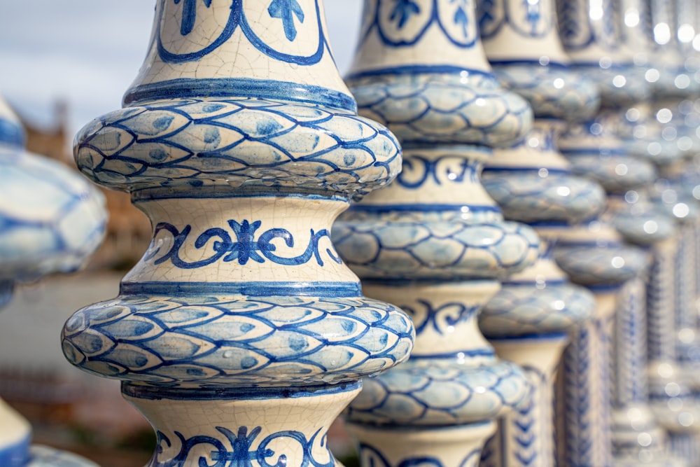 a row of blue and white vases sitting next to each other