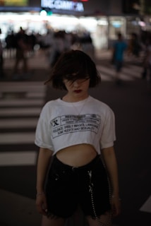 a woman standing in the middle of a cross walk