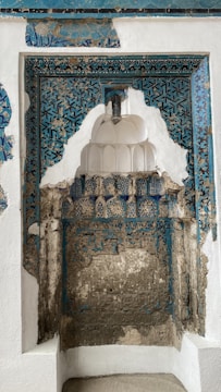 Deconstructed architectural elements with terracotta and slate blue accents on a cream canvas background.