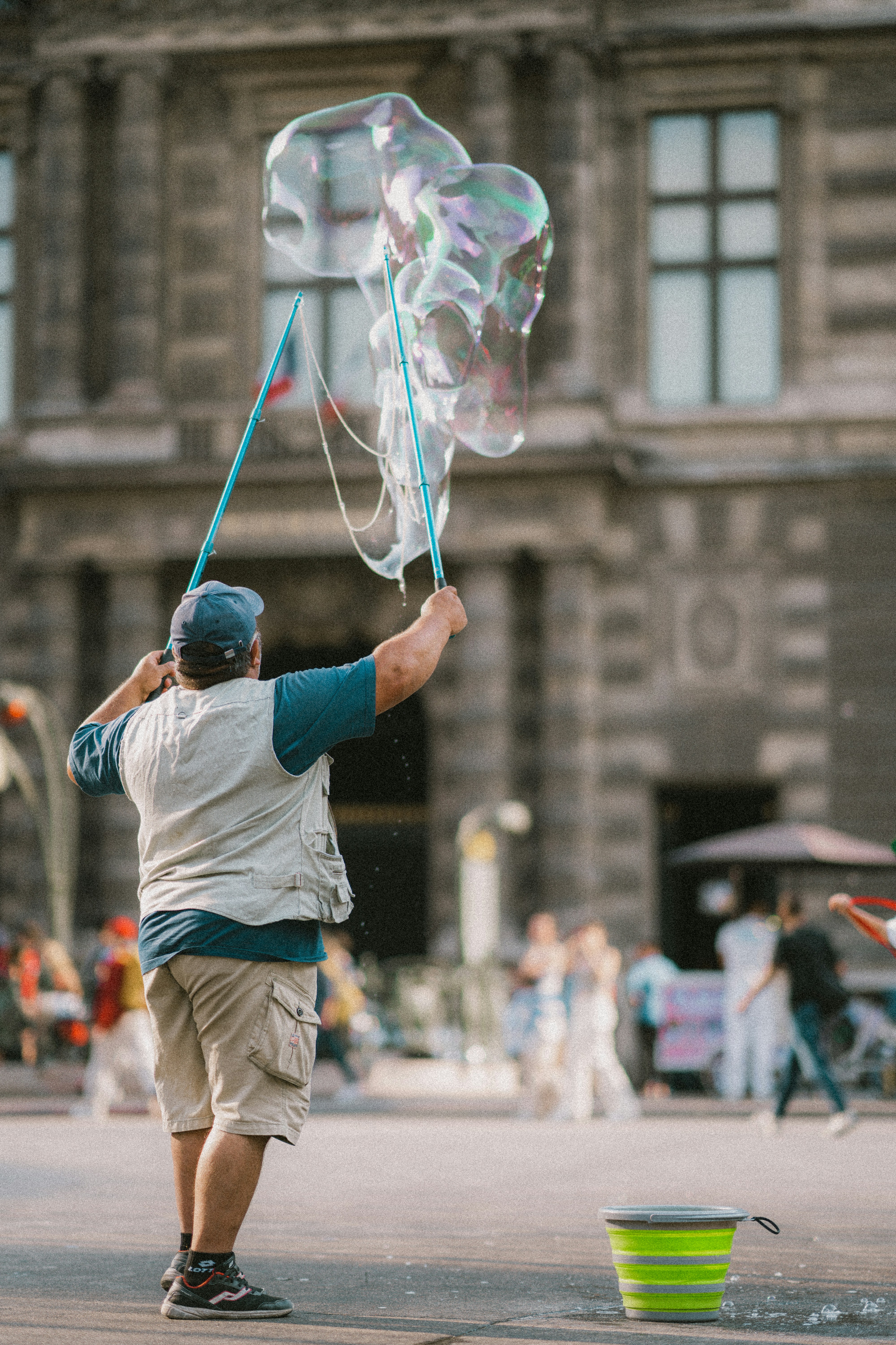 a man is playing with bubbles in the street