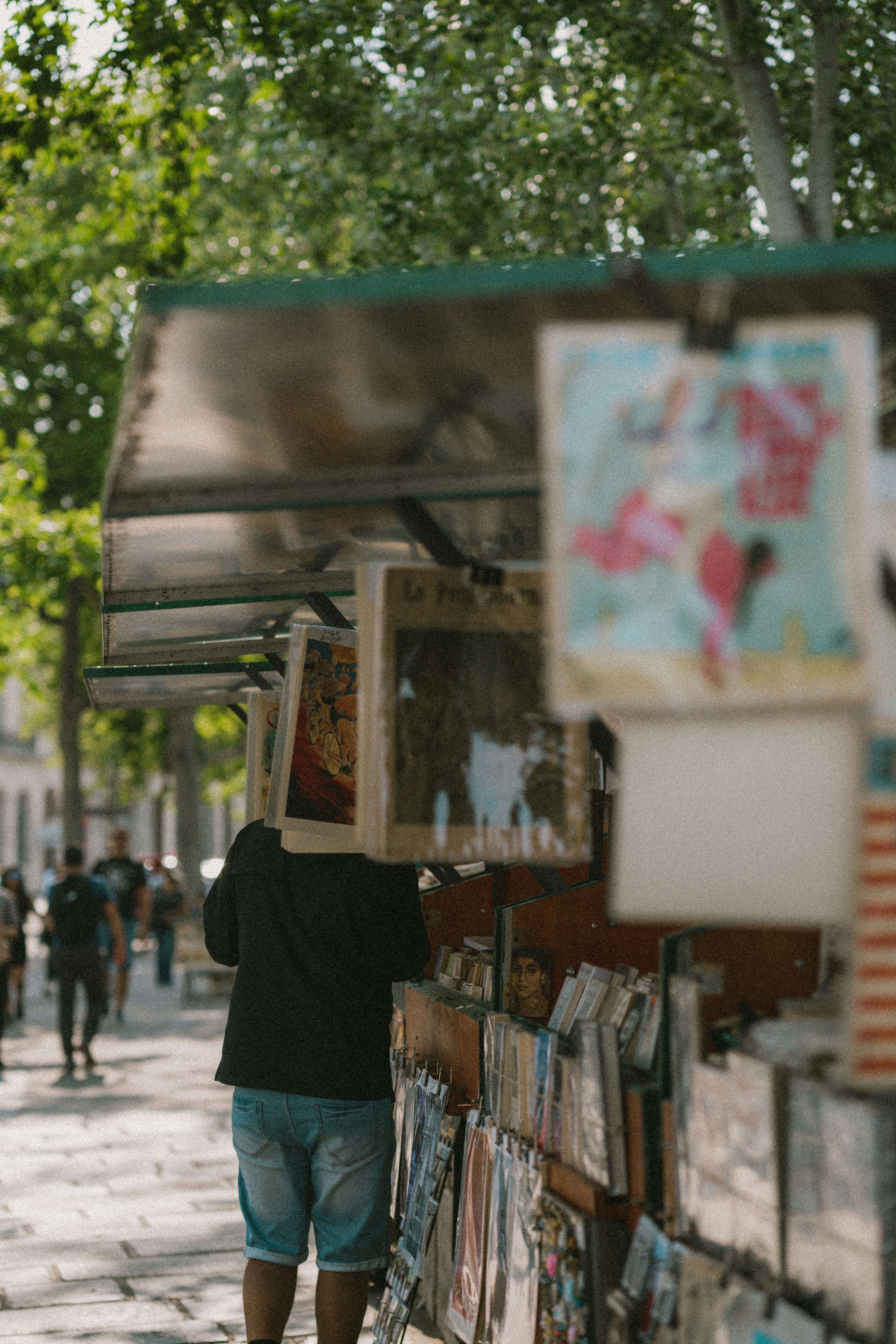 a man walking down a street next to a store