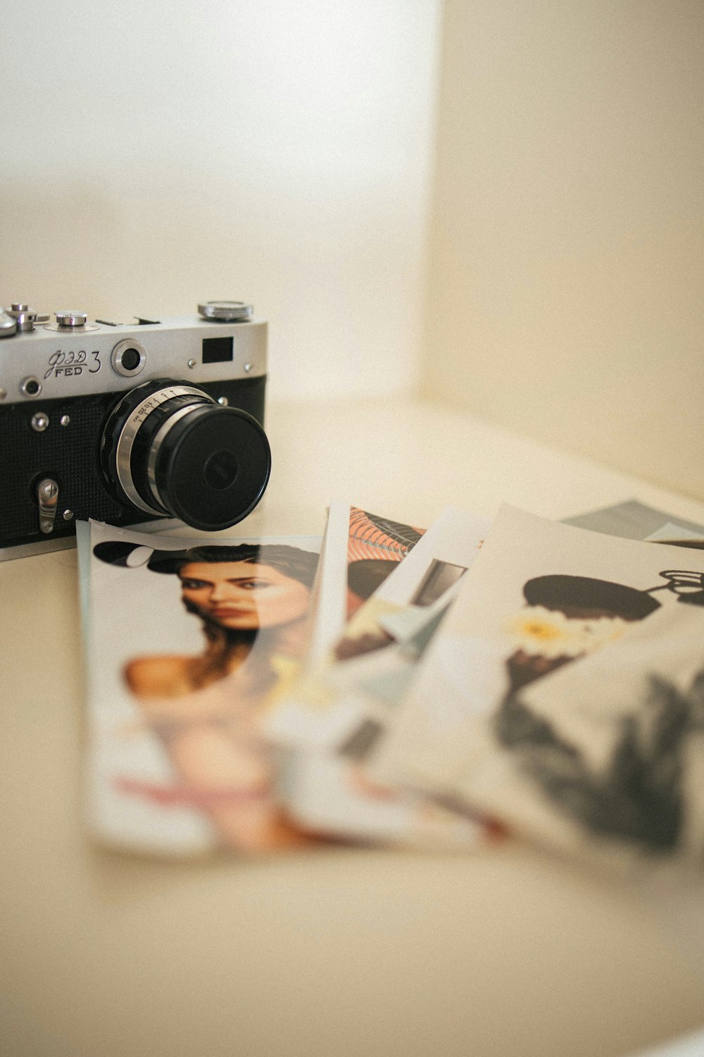 a camera sitting on top of a table next to pictures