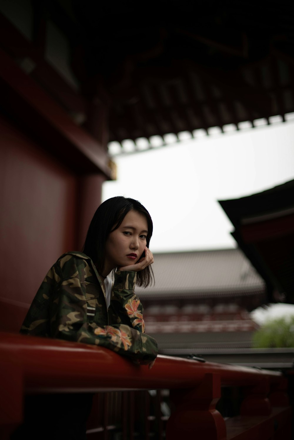 a woman sitting on a red bench talking on a cell phone