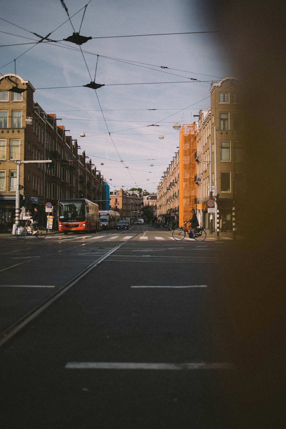 a city street filled with traffic next to tall buildings