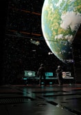 Two figures in space suits stand in a futuristic room facing large windows. The view outside shows a large, detailed planet with clouds and greenery, as well as several spaceships floating nearby. The interior is sleek and metallic, with digital consoles emitting a soft glow.