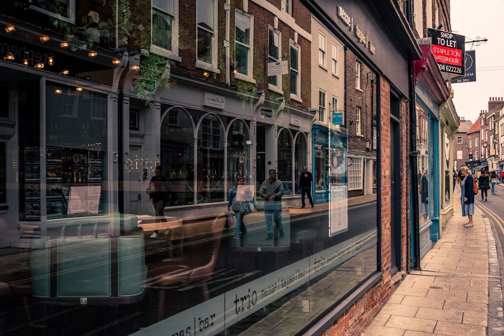 a city street with people walking on the sidewalk