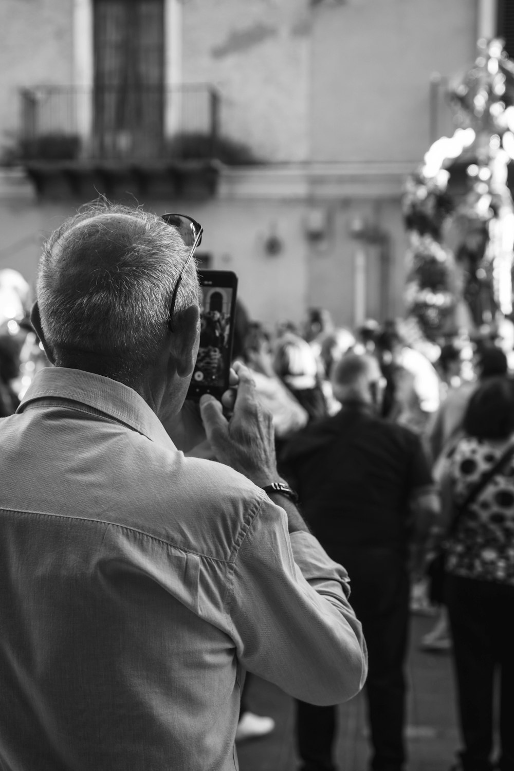 a man taking a picture of a christmas tree