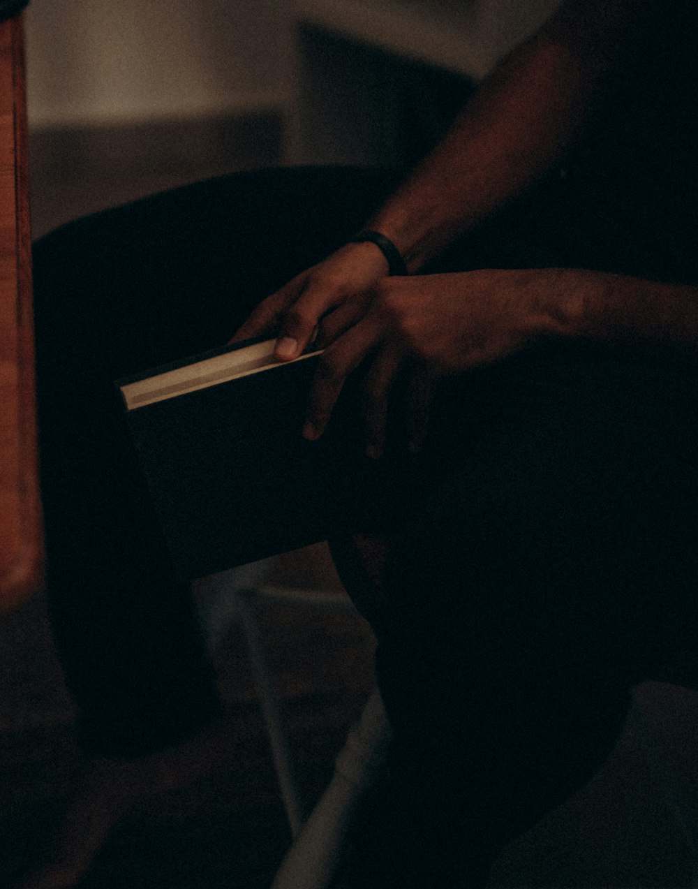 a person sitting on a chair holding a book