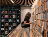 a woman reading a book in a library